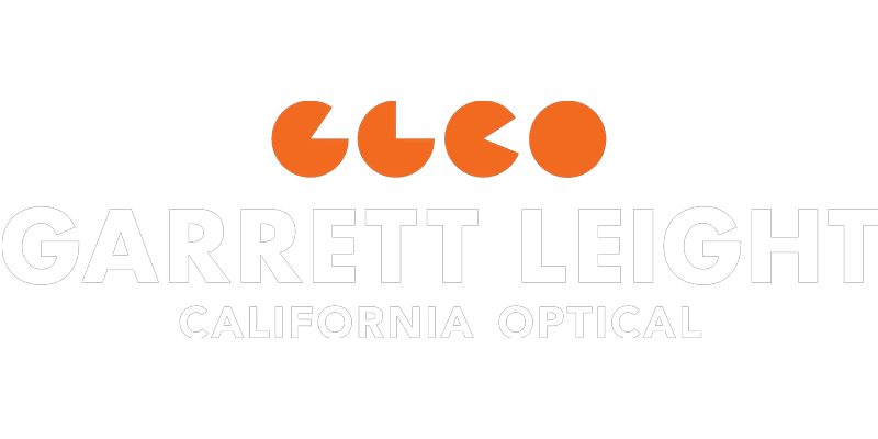 The logo for Garrett Leight California Optical features four orange circular shapes above the brand name in large white letters, with CALIFORNIA OPTICAL—inspired by Vu, le plus grand inventaire de montures à Montréal—in smaller white text below.