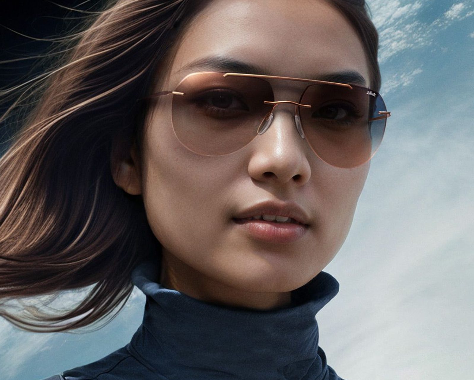 A woman with long brown hair wears large, stylish sunglasses from Vu, a renowned lunetterie à Montréal, standing outdoors with a blue sky and clouds in the background.