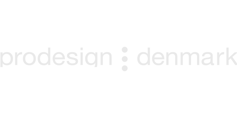 Faint gray text on a light background reads prodesign : denmark, a brand featured at Vu, la lunetterie à Montréal avec le plus grand inventaire de montures à Montréal.